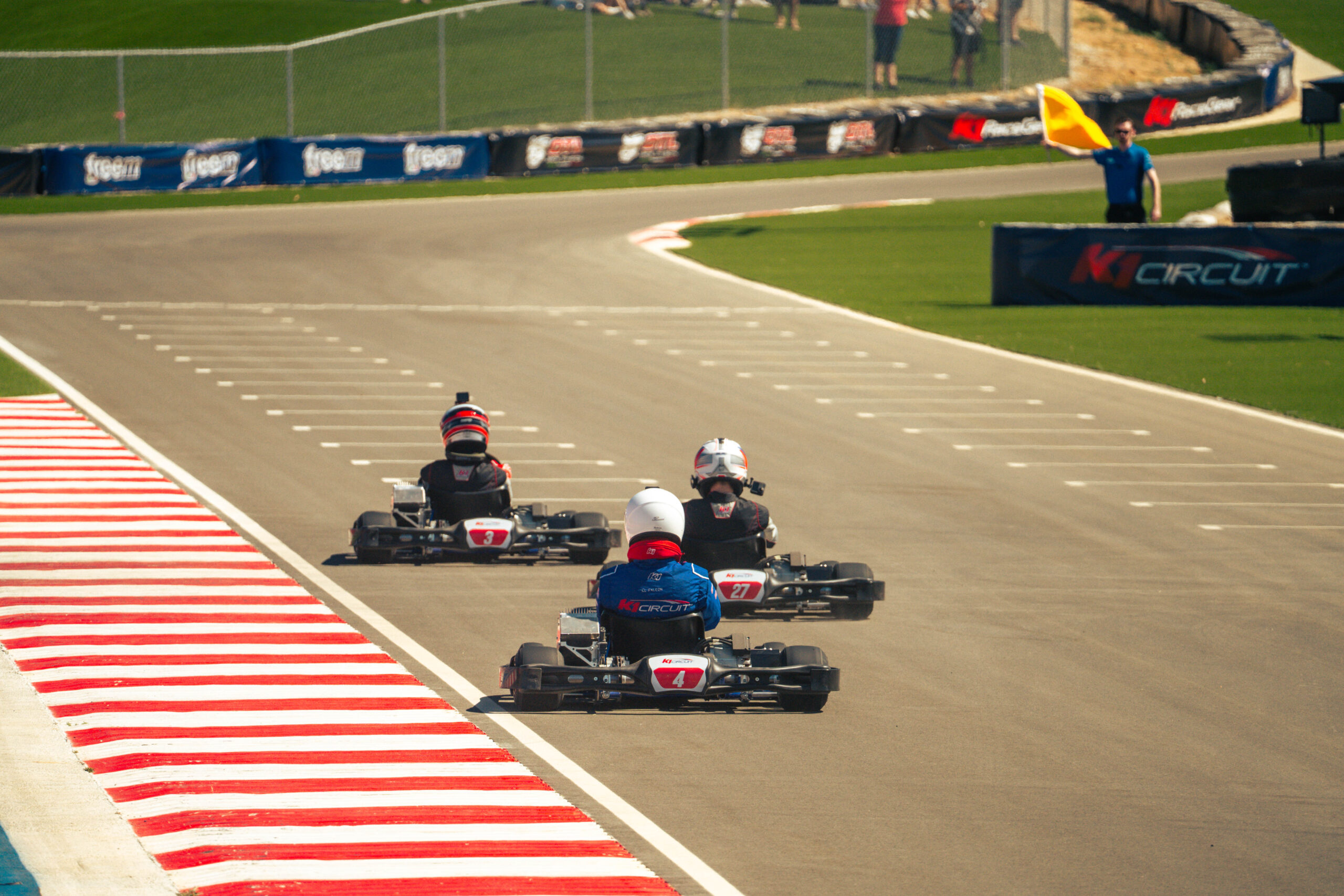 three go karts race down the straight at k1 circuit