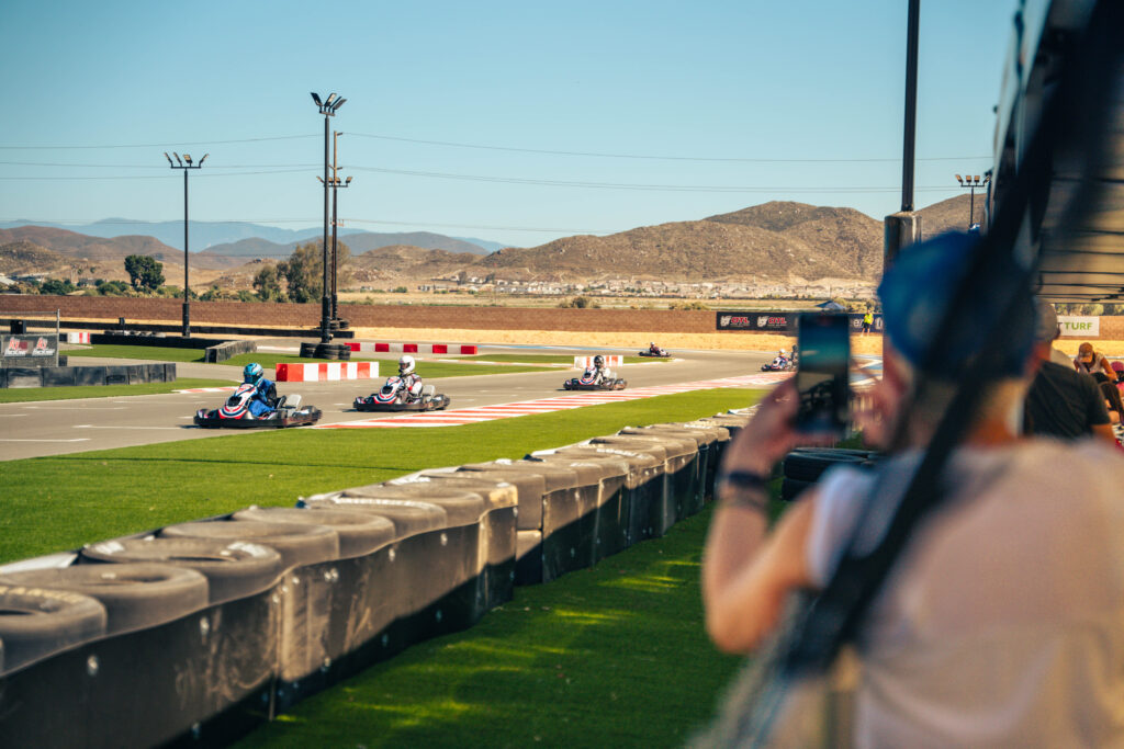 people photograph karts going by at k1 circuit