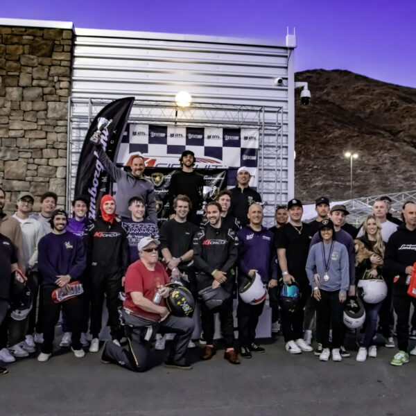 a group poses at the podium at k1 circuit winchester for a corporate event